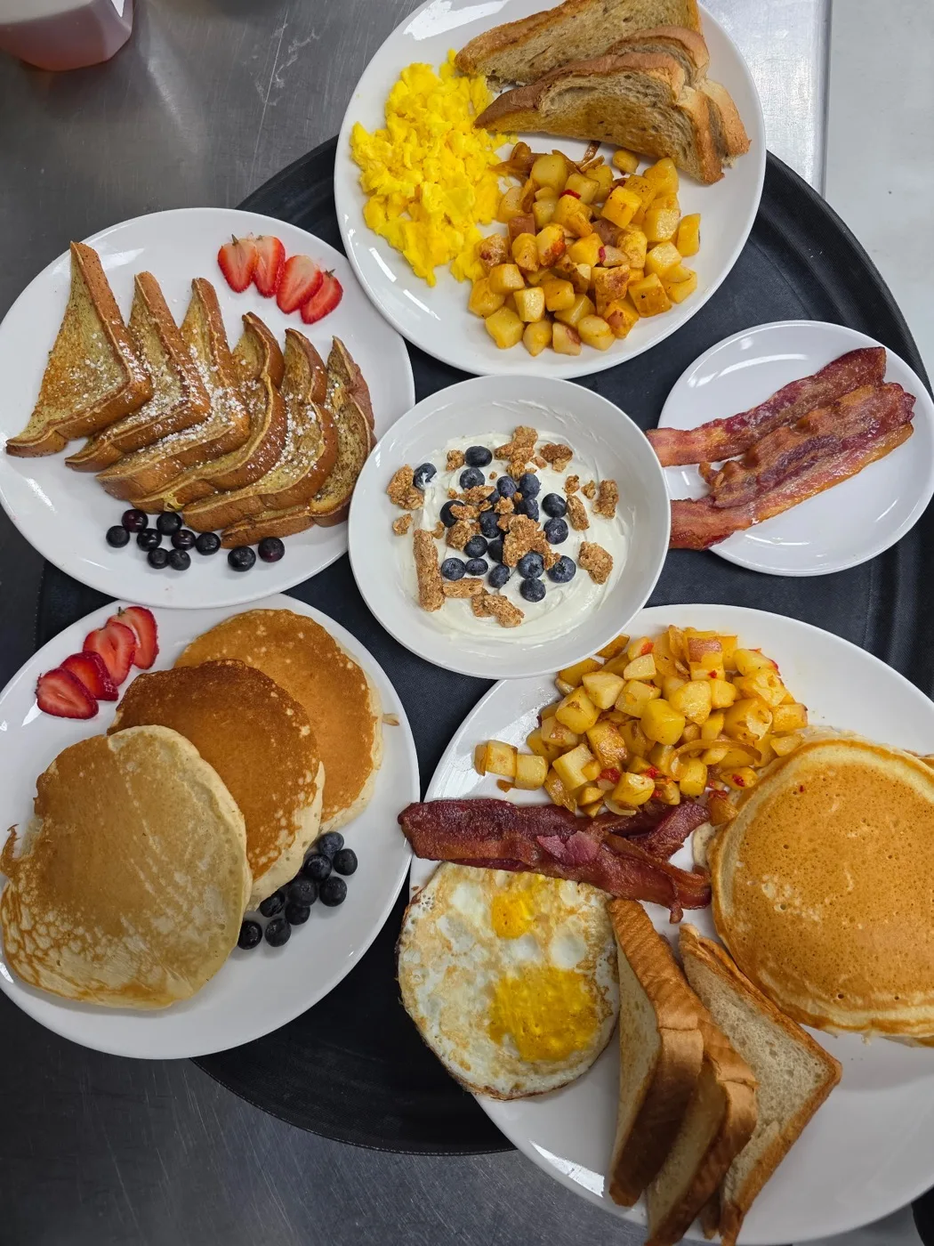 Breakfast plates from Fenimore's Table: French toast, pancakes, scrambled eggs, home fries, bacon and a yogurt parfait with blueberries Breakfast plates from Fenimore's Table: French toast, pancakes, scrambled eggs, home fries, bacon and a yogurt parfait with blueberries